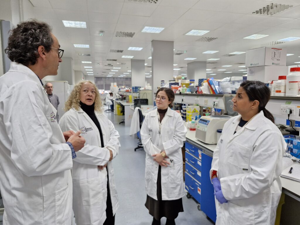 Kim Johnson MP speaking with researchers in the lab at The Pandemic Institute