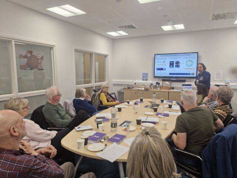Researcher explaining research to public group
